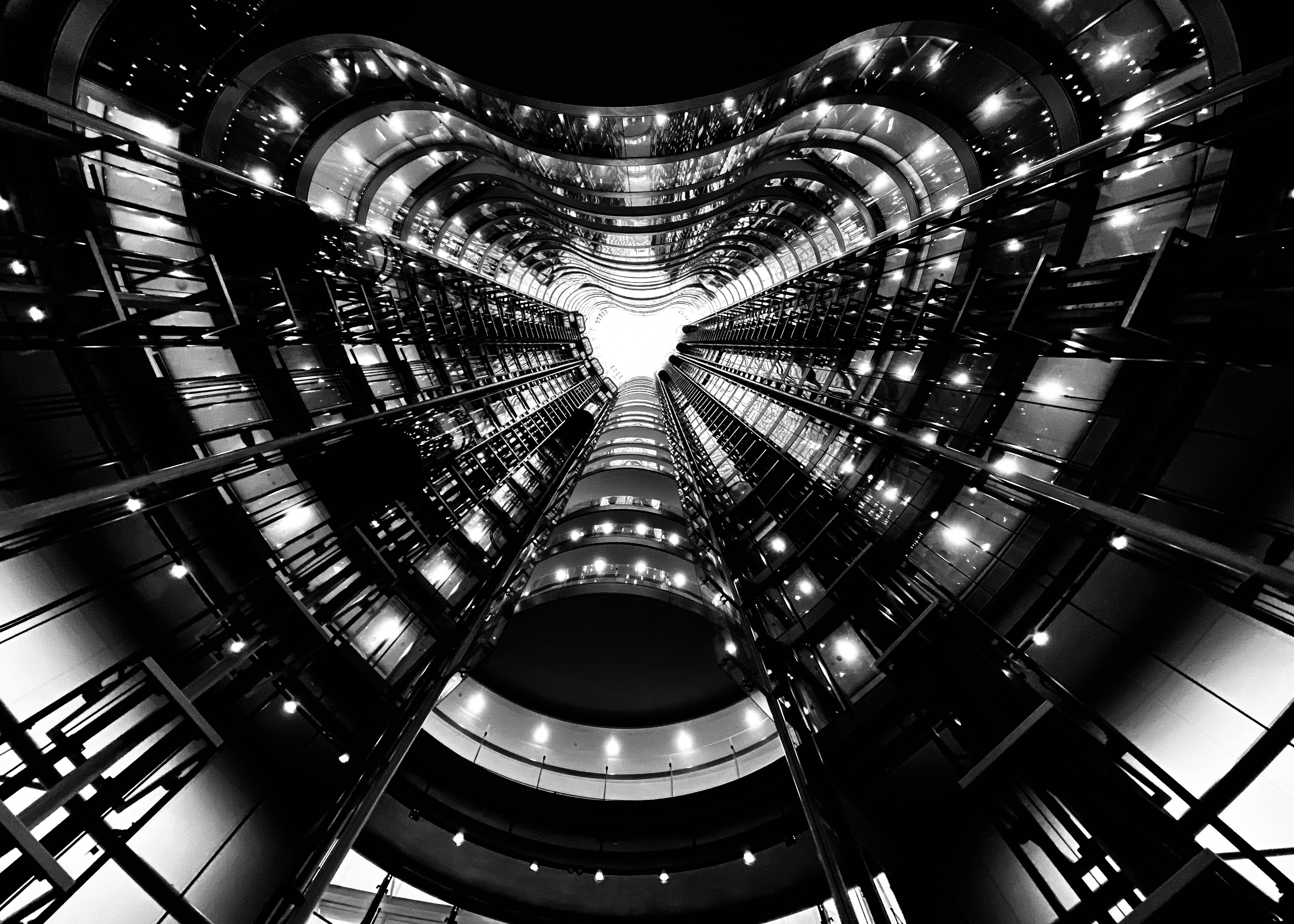 Looking up the centre of the building’s foyer with glass lift shafts